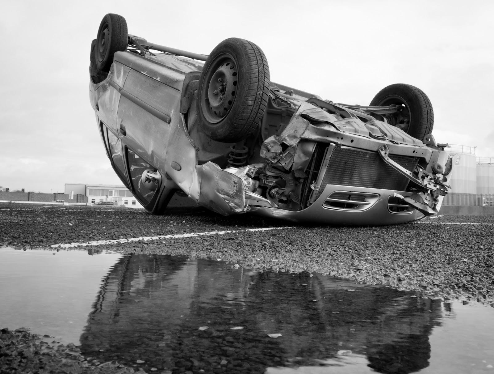 Overturned car after a serious accident on a roadway, illustrating the risks of motor vehicle collisions, vehicle damage, and potential injury outcomes in real-world crash scenarios and car accident stats.